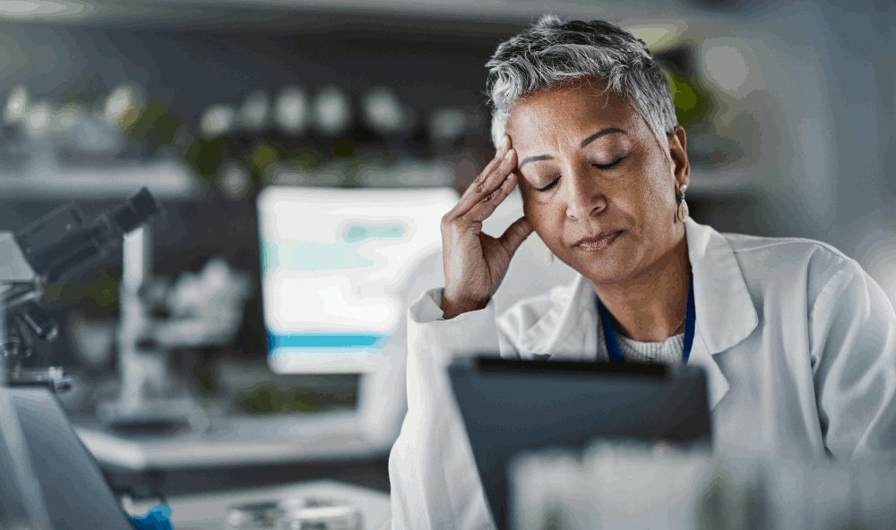 Frustrated scientist looking at document