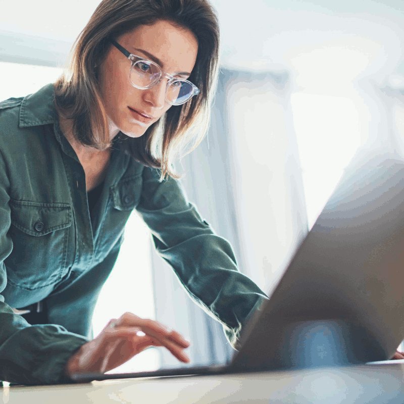 Woman with glasses works on computer